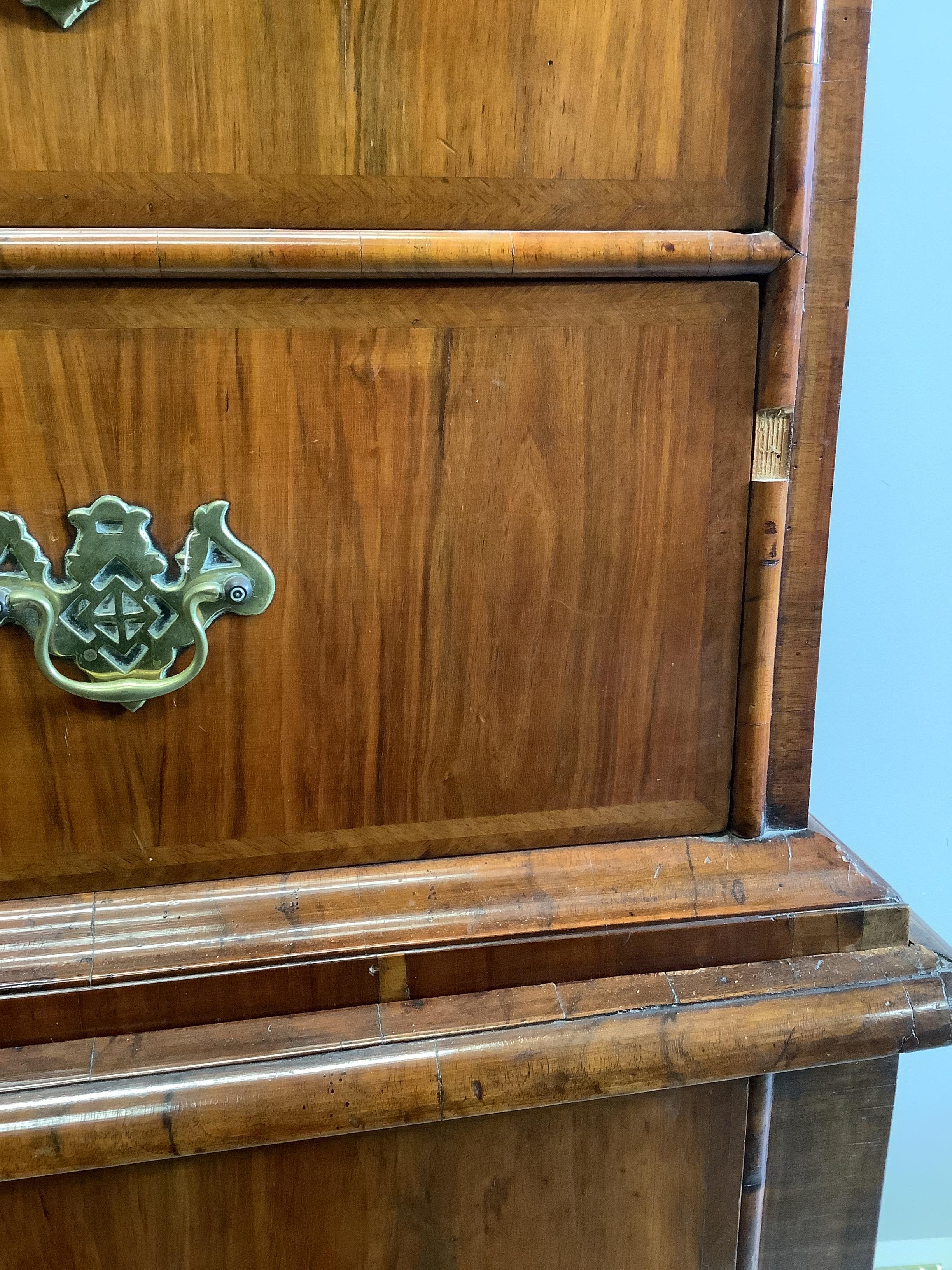 A George I and later feather banded walnut chest on stand, width 103cm, depth 58cm, height 167cm